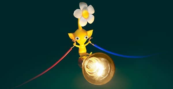 A picture of a Yellow Pikmin holding two exposed electric wires and powering a light bulb.